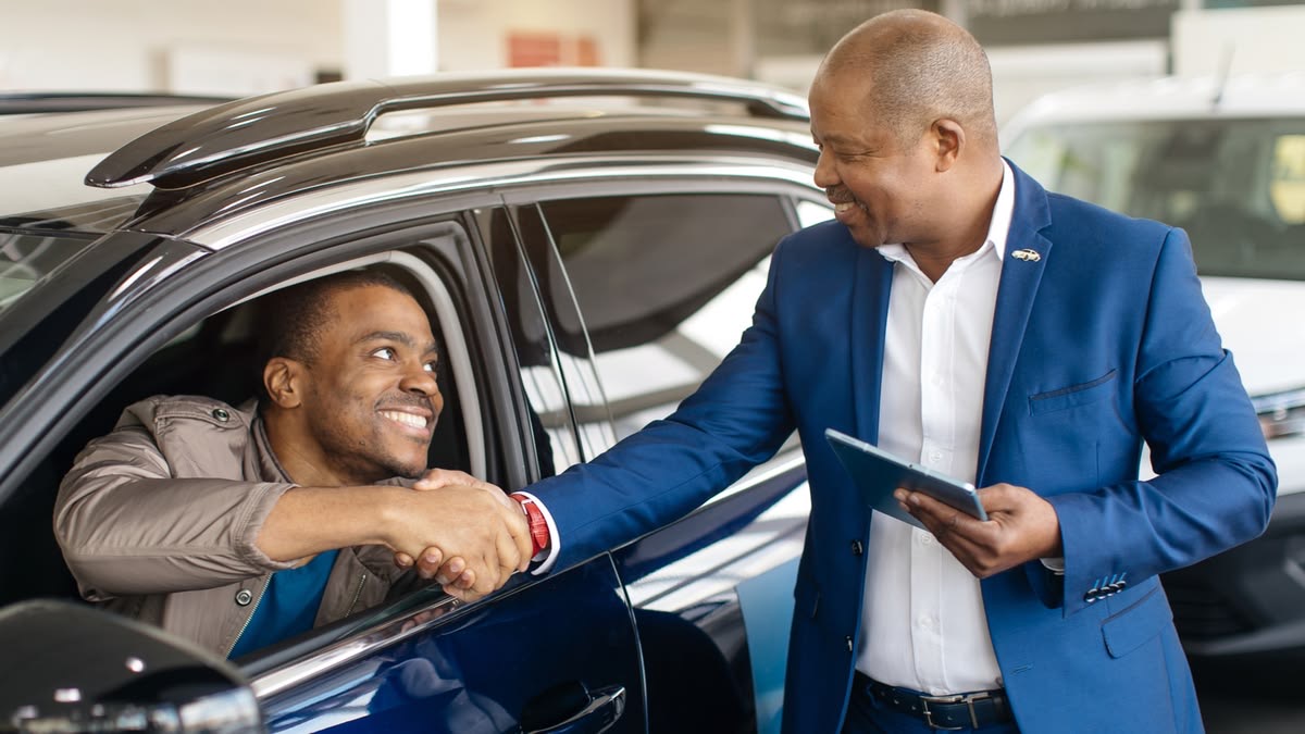 Remise de clés entre particuliers devant un véhicule — OnCars